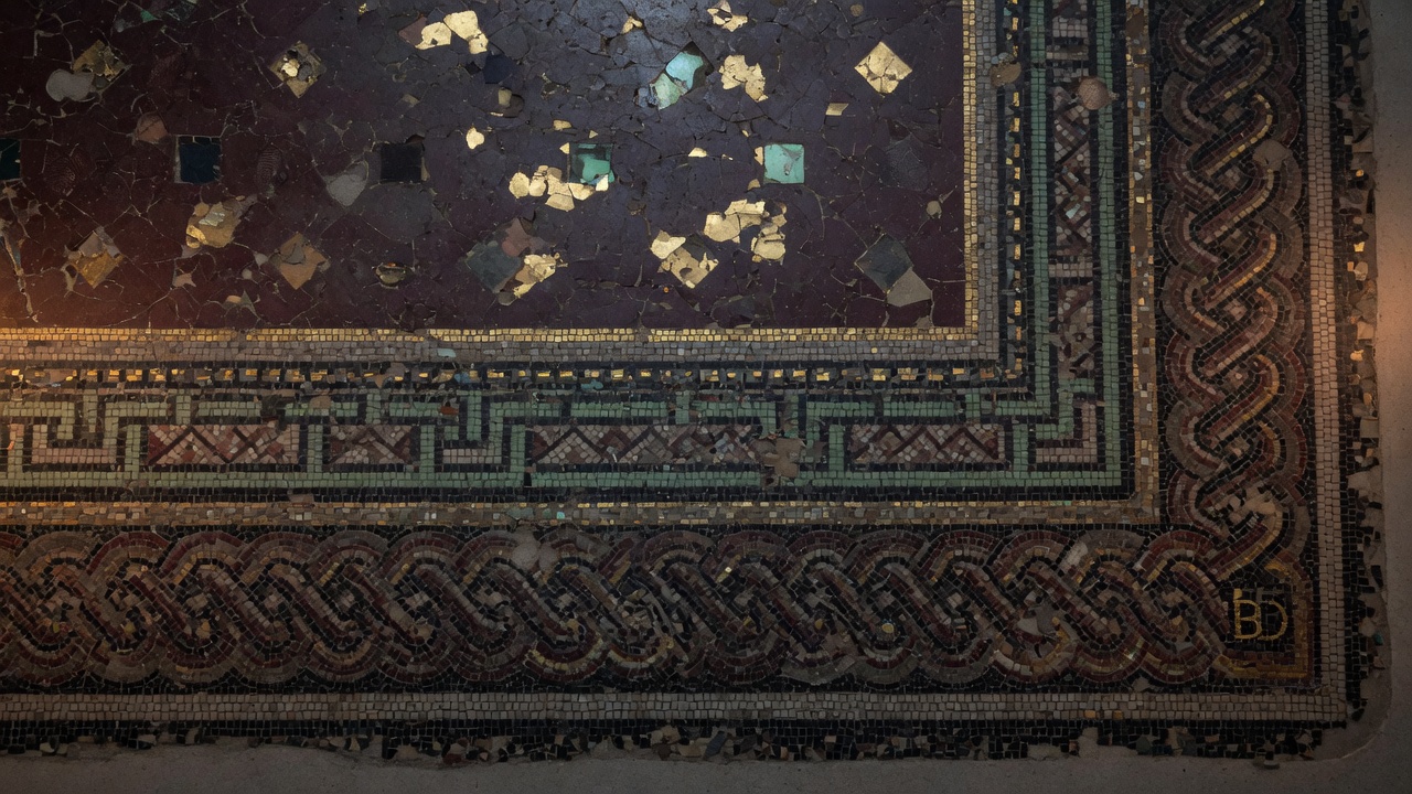 Porphyry mosaic floor with a tiny mason's mark, B D, in the corner.